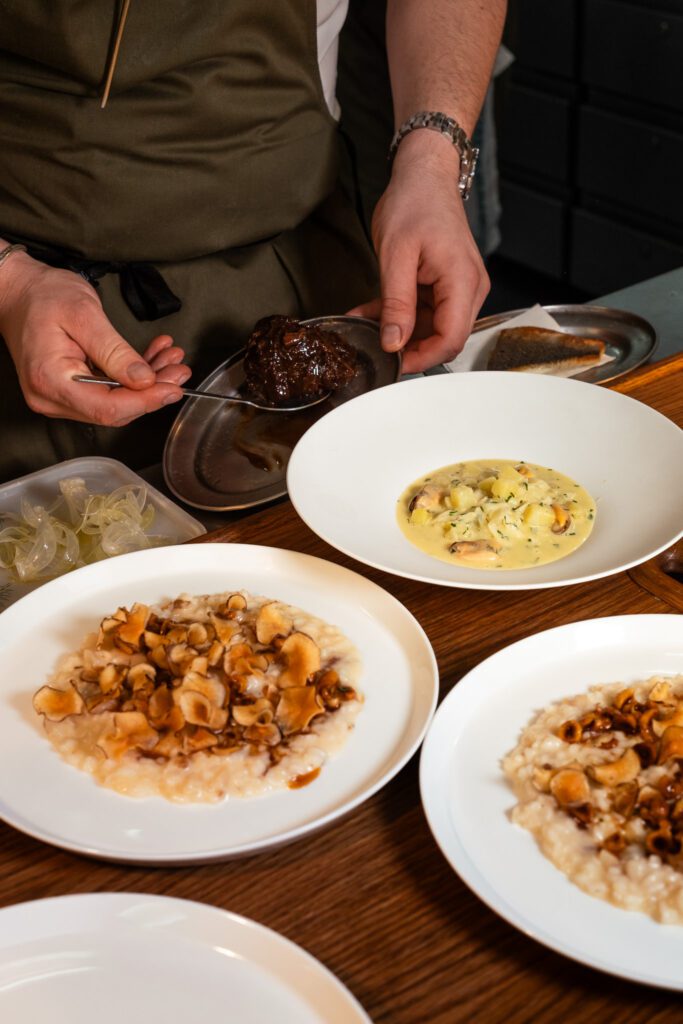 Chef preparing several dishes at Murano