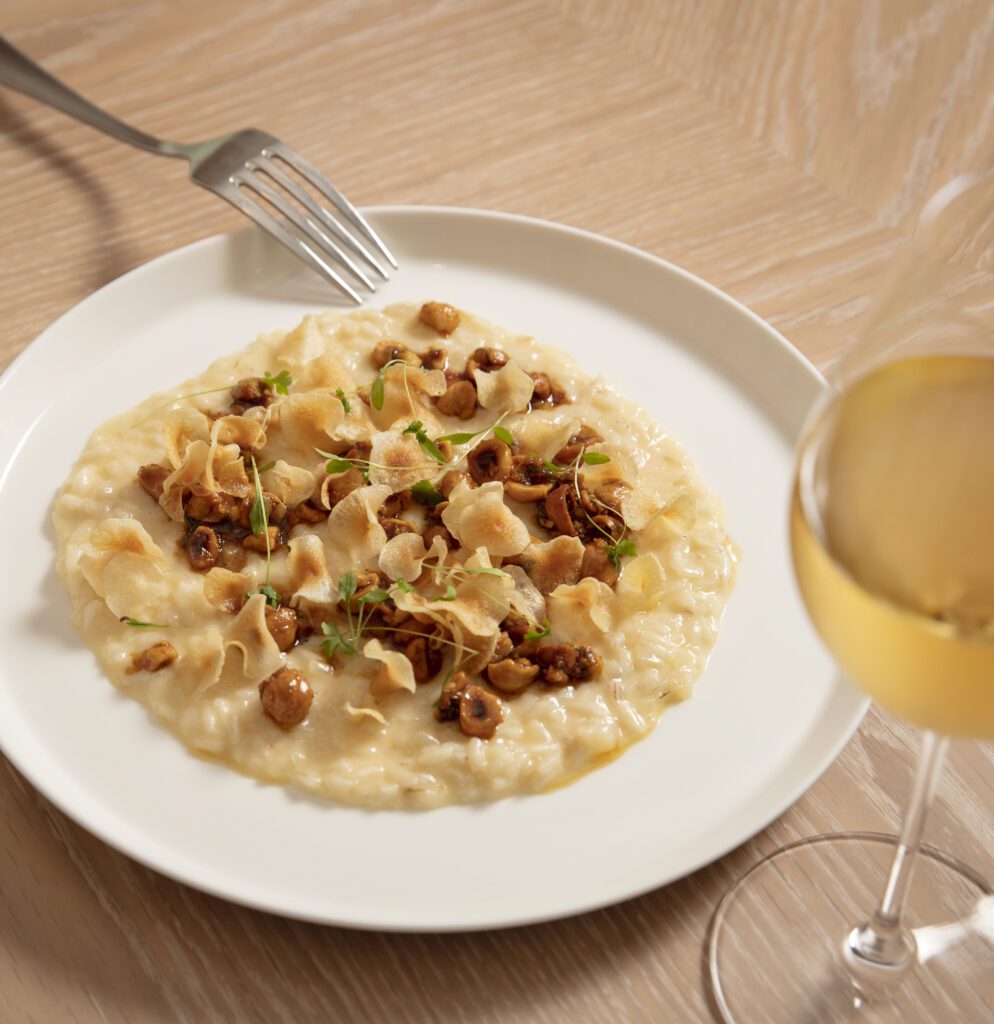 Murano risotto with a glass of white wine